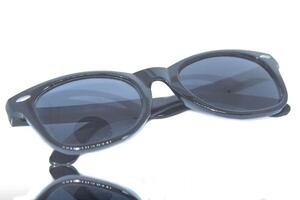 A pair of sunglasses with black frames and mirrored lenses photo