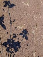 stark, black and white image of a tree branch shadow cast on a rough, textured concrete wall. Perfect for minimalist or abstract design projects. photo