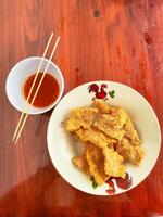 Delicious Fried Soybean Cake Tempe Served on a Plate as Savory and Crunchy Snack photo