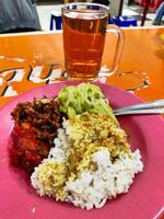 Traditional Indonesian Warteg Food Served with Orek Tempe, Labu, and Gulai Sauce photo