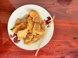Delicious Fried Soybean Cake Tempe Served on a Plate as Savory and Crunchy Snack photo