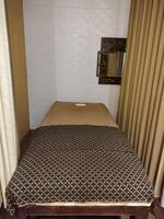 Cozy and Tranquil Massage Room with Soft Lighting and Comfortable Bed photo