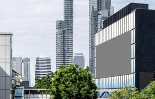 Mock up gray LED display billboard on modern building with cityscape background .Clipping path for mockup photo