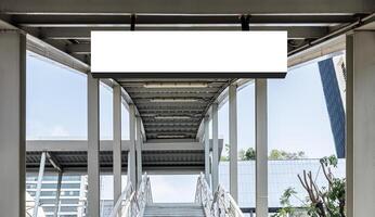 Mock up hanging white rectangle billboard at footbridge photo