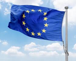 European Union flag pole with blue sky background photo