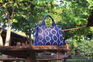 Indigo blue shoulder bag made from fabric with tie dye and shibori dyeing techniques photo