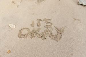 Motivation quotes it is okay written in the sand of the beach photo