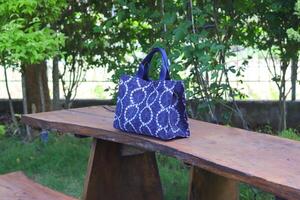 Indigo blue shoulder bag made from fabric with tie dye and shibori dyeing techniques photo