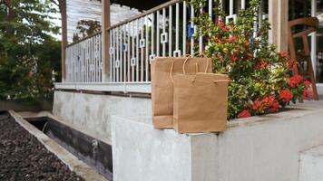 Package of paper bags lying in front of the house photo