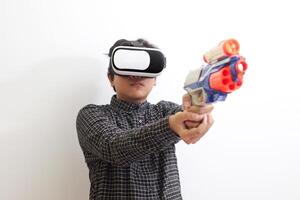 Portrait of Asian man in black plaid shirt using Virtual Reality VR glasses holding a gun weapon console. Isolated image on white background photo