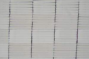 Stacks of books after going through printing production in the offset industry. Pile of books ready to enter the finishing stage of lamination photo