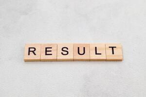 Top view of Result word on wooden cube letter block on white background. Business concept photo