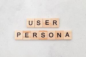 Top view of User Persona word on wooden cube letter block on white background. User interface and experience concept photo