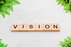 Top view of Vision word on wooden cube letter block on white background. Business concept photo