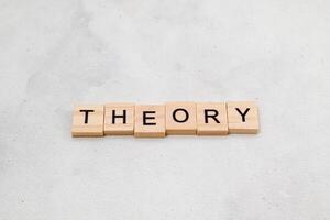 Top view of Theory word on wooden cube letter block on white background. Business concept photo