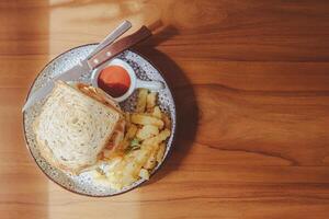 Whole wheat sandwich toast with crispy chicken, sunny side egg, and sauce. Breakfast concept in the morning photo