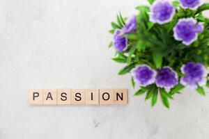 Top view of Passion word on wooden cube letter block on white background. Business concept photo