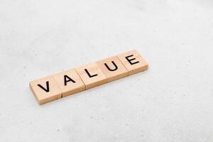 Top view of Value word on wooden cube letter block on white background. Business concept photo