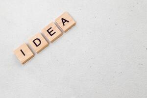 Top view of Idea word on wooden cube letter block on white background. Business concept photo