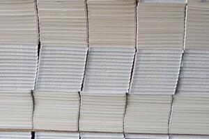Stacks of books after going through printing production in the offset industry. Pile of books ready to enter the finishing stage of lamination photo