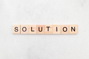 Top view of Solution word on wooden cube letter block on white background. Business concept photo