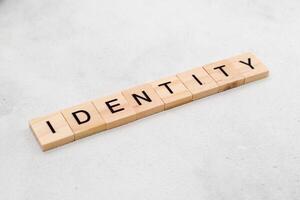 Top view of Identity word on wooden cube letter block on white background. Business concept photo