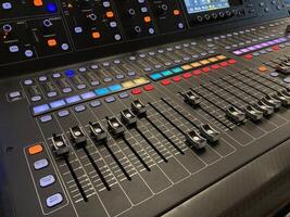 a large mixing board with multiple knobs and buttons photo