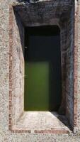 A small pool of water in a brick building video