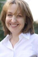a woman in a white shirt smiling photo