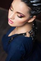 Beautiful young brunette woman with fantasy makeup and hair dress photo