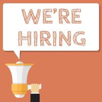 hand holding megaphone with we're hiring sign in front of it vector