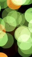 Abstract colorful golden circles falling down slowly on black background, seamless loop. Animation. Bokeh pattern with small particles looking like falling snow. video