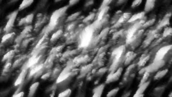 Abstract ripples and liquid surfaces with shiny lines. Motion. Bright highlights in moving ripples on black background. Geometric flickering highlights of light in liquid ripples video