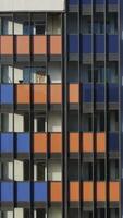 Close-up view facade of the beautiful colorful of a tall residential building. Motion. High-rise buildings modern architecture skyline. video