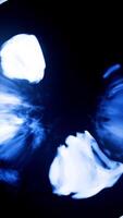 Futuristic smoke creating glowing circle on a black background. Media. Neon blue color, round mystical portal. Vertical . video