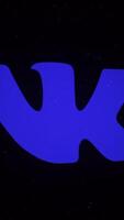 Digital animation of VKontakte app icon decaying into multicolored moving plexus networks on black background. animation. Animation. Technology, social media and internet backdrop. video