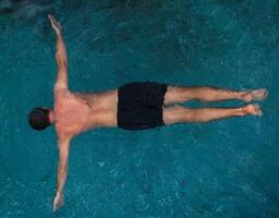 Athletic man swimming in the pool photo