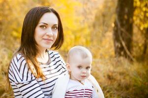 Mother with her baby daughter in autumn park photo