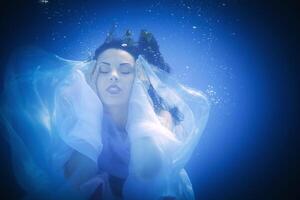 Underwater close up portrait of a woman photo