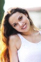 Young beautiful natural brunette woman at summer sunset portrait photo