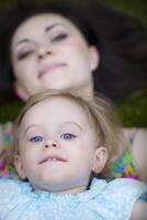 Beautiful young mother with daughter having fun photo