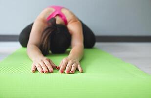 Young woman doing exercises on the floor photo