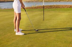 Golf player practicing to hit the ball at the course photo