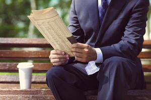 Close up of the hands of the businessman with a newspaper photo