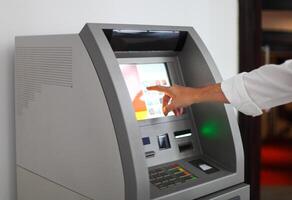 Man using banking machine photo
