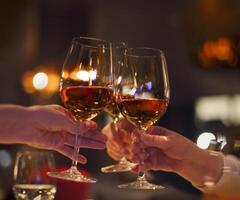 Toast in restaurant with full glasses of rose wine photo