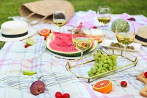 Picnic with white wine on green grass photo