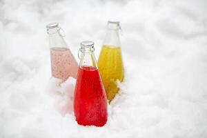 Three healthy drinks with chia seeds ion the snow. Health and diet concept photo
