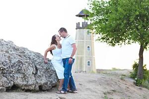 Happy couple posing on a summer day under a tree photo