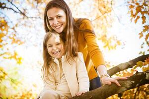 Two cheerful sisters playing in the park photo